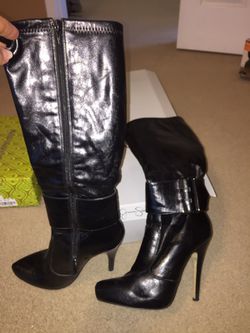 Pair of black leather side-zipped heeled thigh-high boots size 7. normal wear