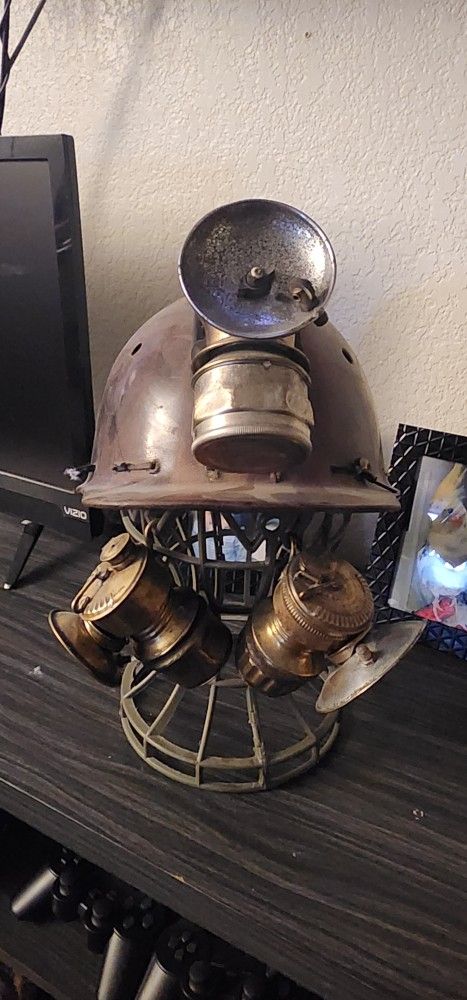 Helmet made of leather that was used by old miners, with three carbide lamps, more than 100 years old.