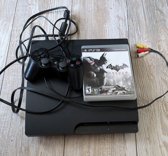 PS3 with controller and batman game