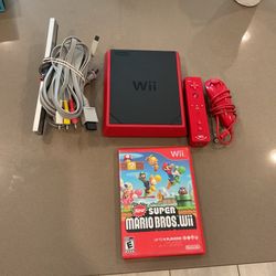 Red Nintendo Wii with super mario bros