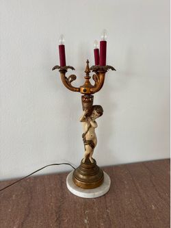 Antique Neoclassical figural candelabra table lamp, featuring a cherub or putti figurine holding a candelabra