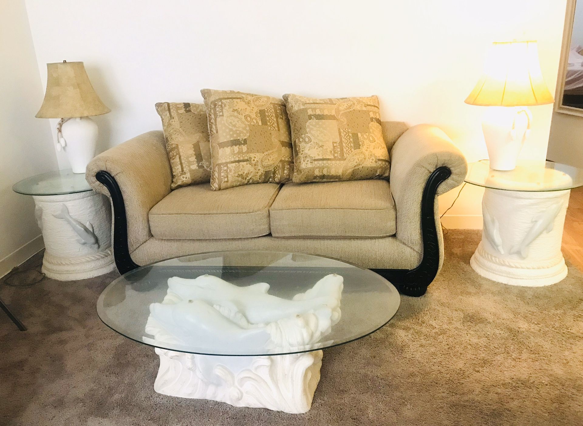 Beige sofa, glass top coffee table & side tables, 2 lamps, and wooden swivel off white chair