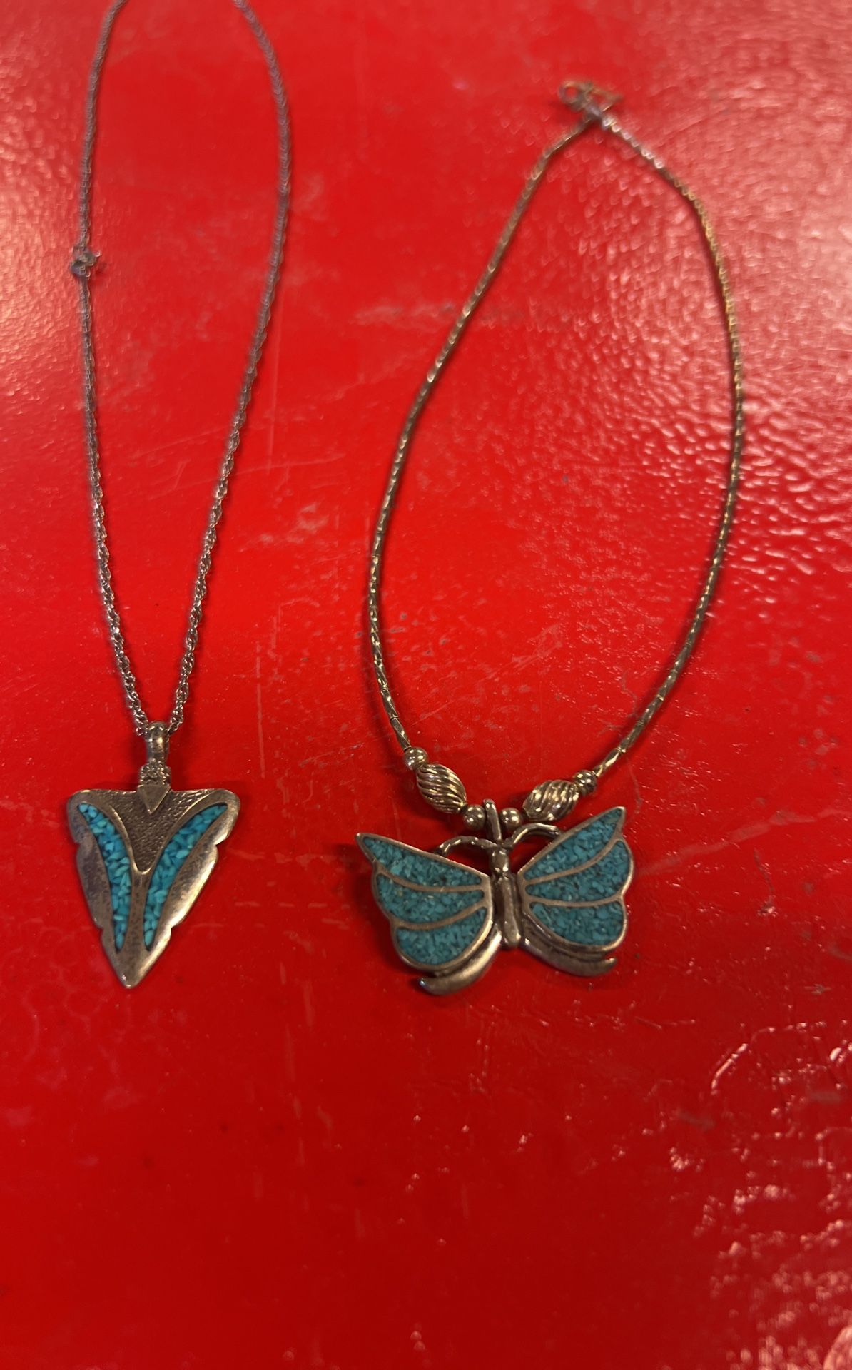 Two necklaces, silver with blue turquoise, arrowhead, and butterfly