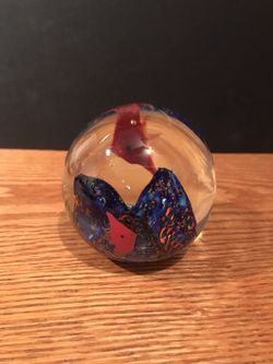 Colorful glass paperweight with fish