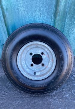 One used tire w/ galvanized rim 5.70-8