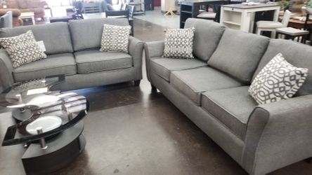 Traditional grey sofa and loveseat with accent pillows