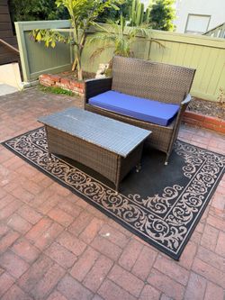 Outdoor loveseat and rug set