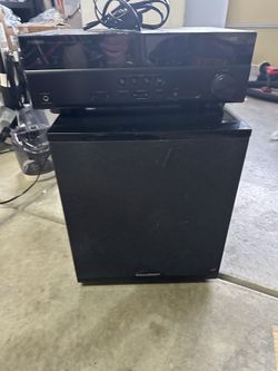Yamaha RX-V673 7.2-channel AV receiver stacked on a BIC Acoustech powered subwoofer