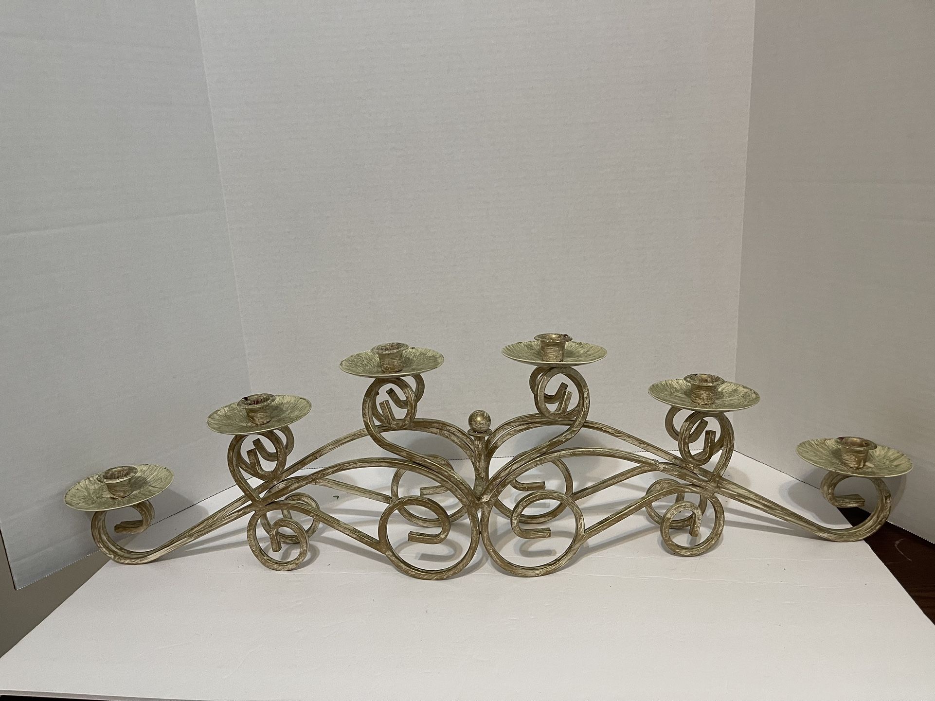 Ornate metal, hand painted candle holder. Holds six candles.  