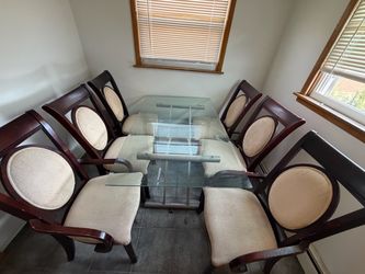 Glass table with wood chairs.