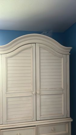 Queen size bed with almost new pillow top mattress and matching armoire.