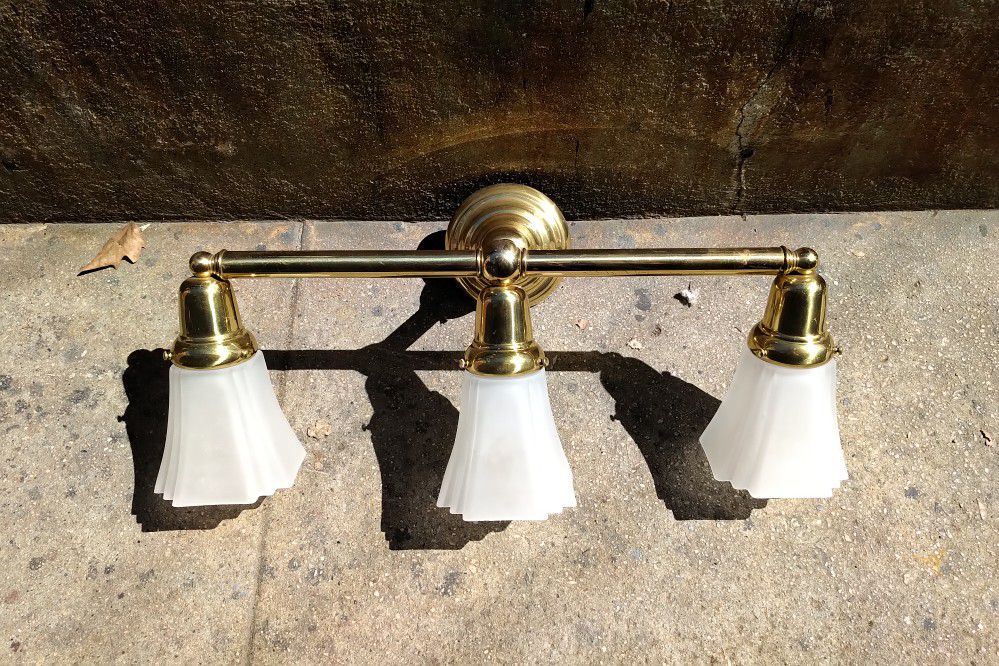 Two brass wall mount 3 light fixtures. Barely if ever used or store display models.