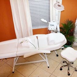 White esthetician facial chair & multifunctional steamer. 