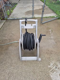 Garden hose reel with 100ft garden hose.