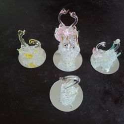 GORGEOUS NEW Set of 5 Spun Glass Swan figurines.

Enhance your collection with a stunning set of 5 Spun Glass Swan figurines.
