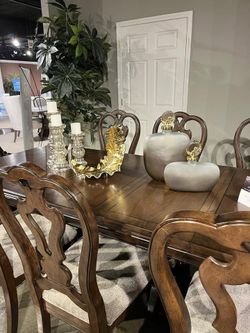 Brown finish dining set features large dining table w/2 extension leaf