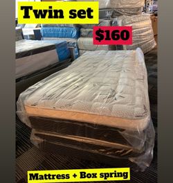 Twin size pillow top mattress with box springs