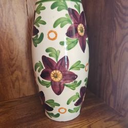 The Schramberg SMF Art Pottery Floral Vase features a beautiful design with majolica green and purple flowers, originating from Germany. This decorati