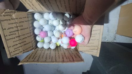 Assorted used golf balls. Random names and conditions.
