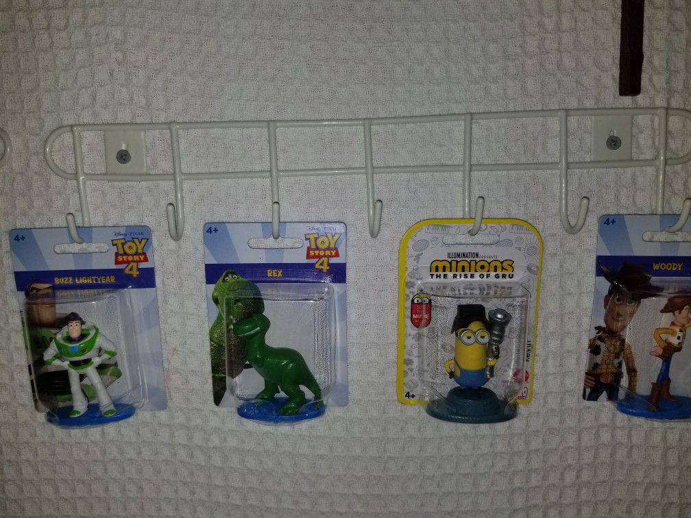 (4) COLLECTABLE FIGURINES FROM TOY STORY 4 AND MINIONS