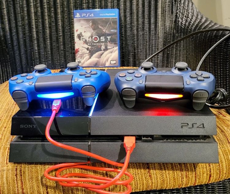 PlayStation 4 With Controllers And Ghost Of Tsushima