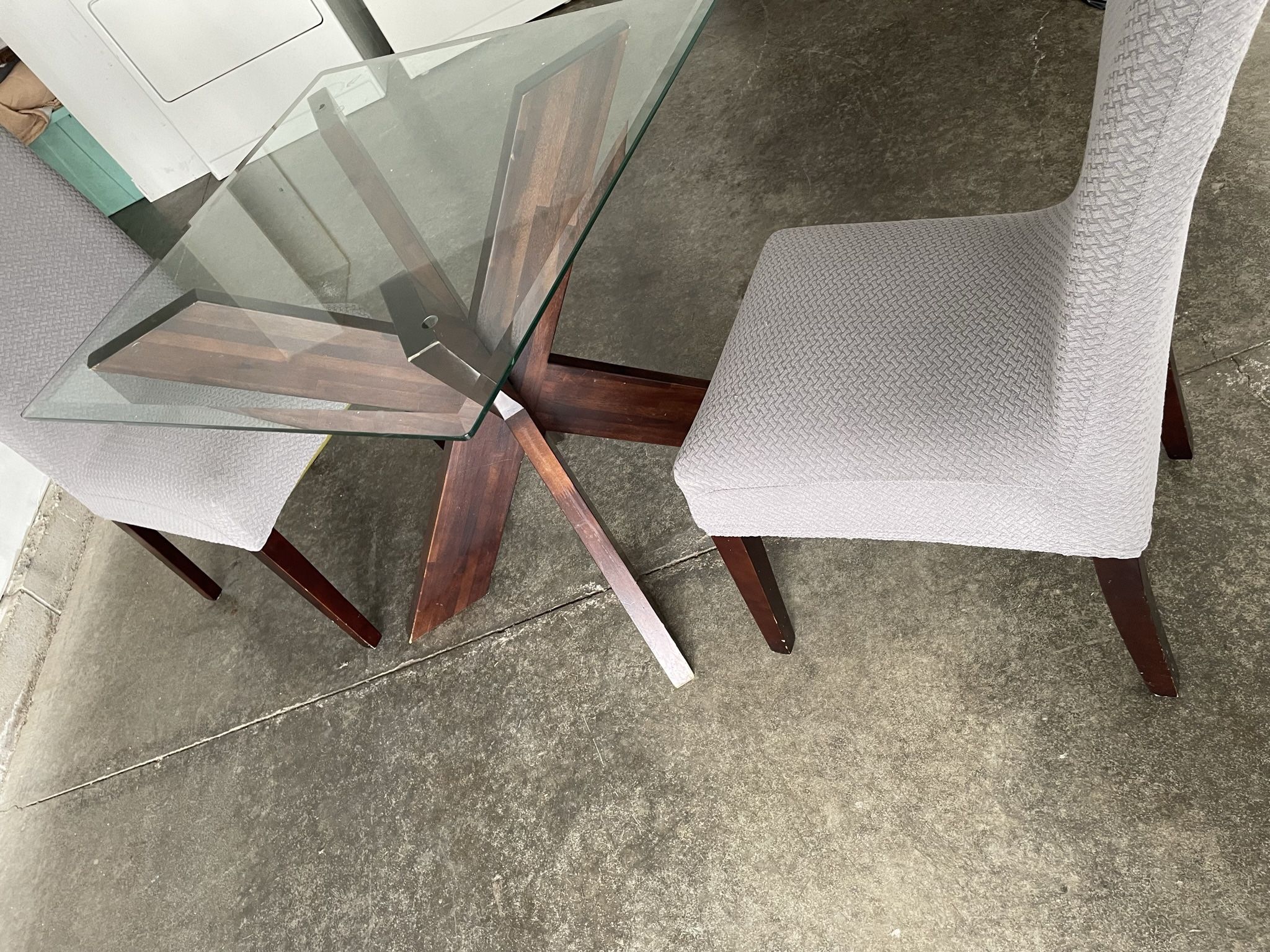 glass table with chairs with covers 