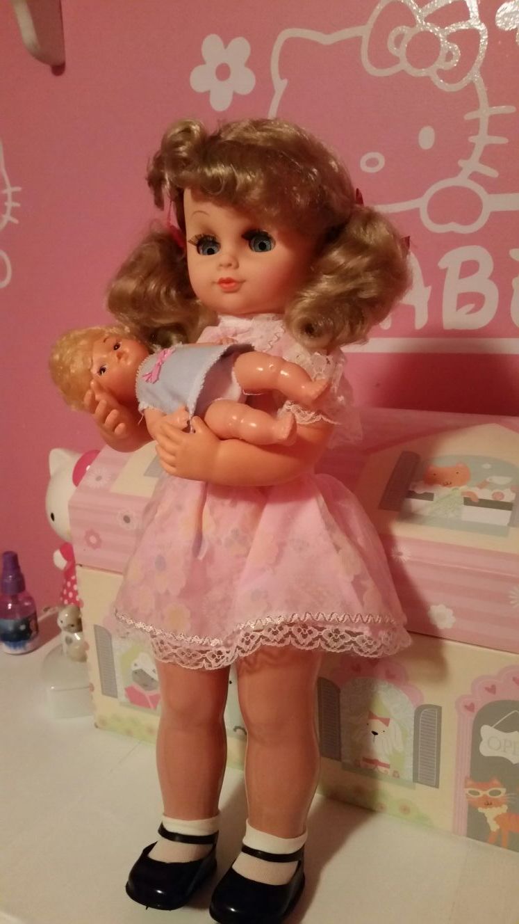 June & Julie # 7805S is a Vintage wind up musical toy doll from the 70's/80's. She is 19" tall & the baby doll is 6 1/2" long.