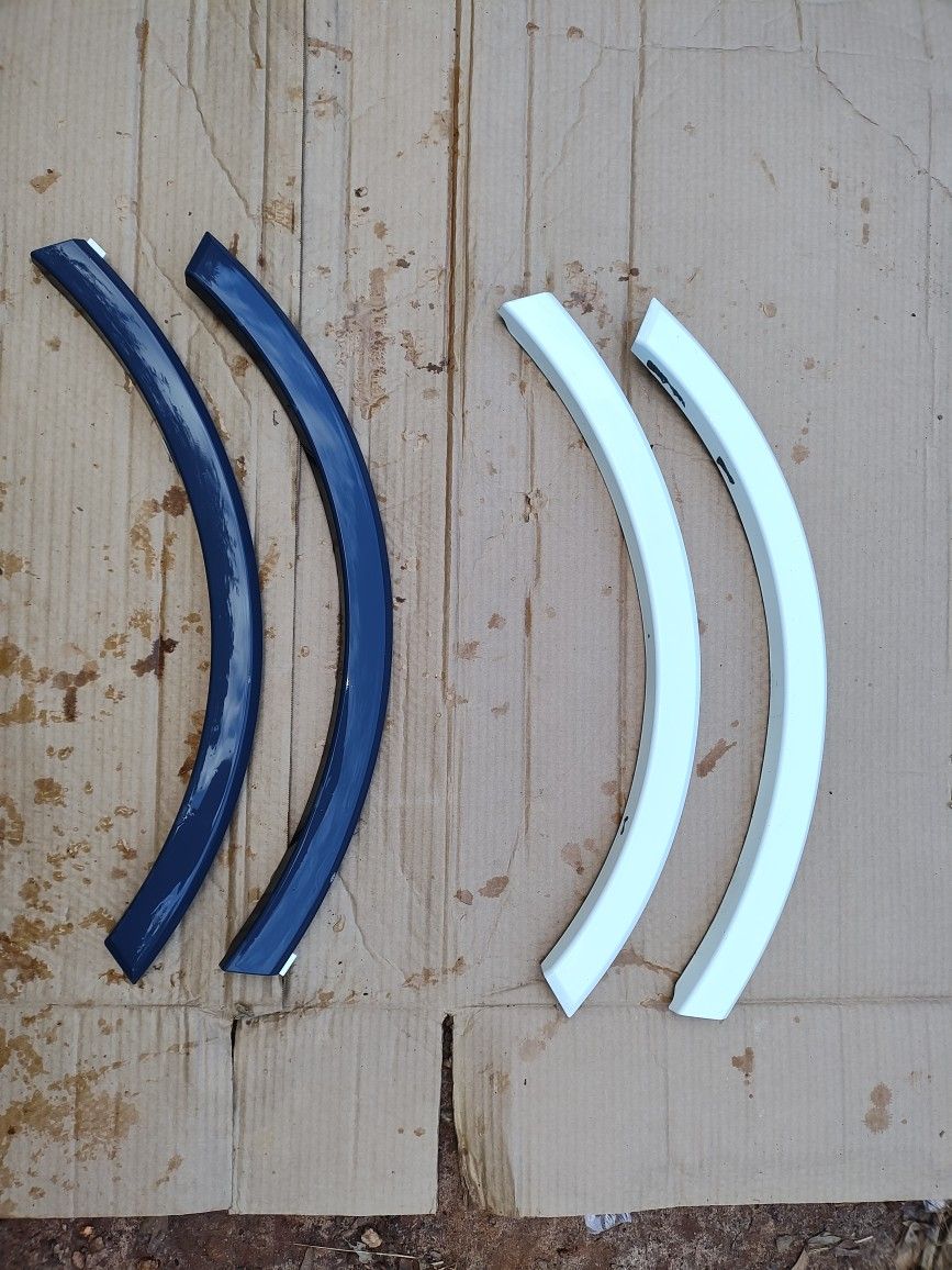 Two Pair Of Audi Fender Flares. One Painted White One Brand New