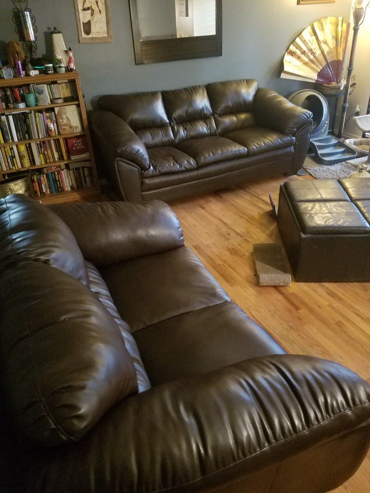Brown leather couch and loveseat