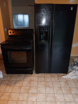 Kenmore convection oven and and GE side by side refrigerator with ice Maker and water.