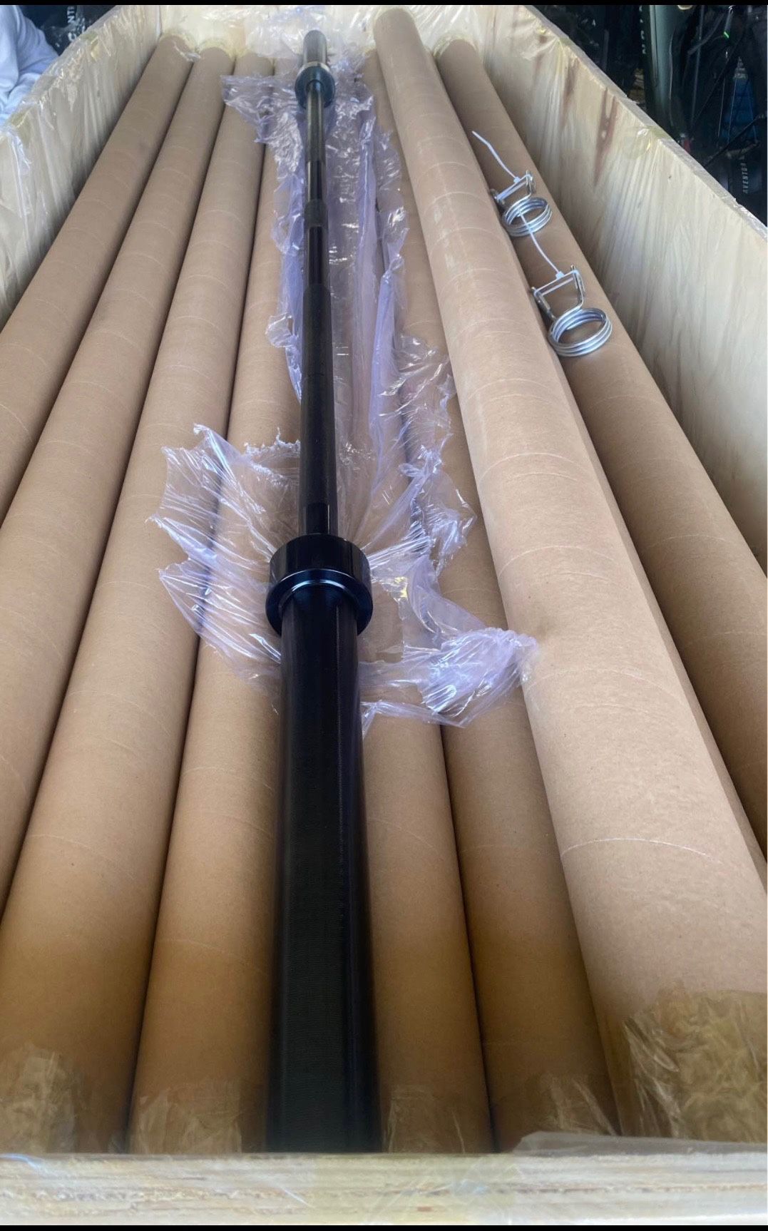 New seven footer black Olympic bar weight 45 pounds it comes with clamps already