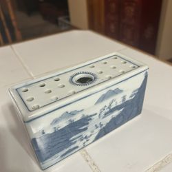 Chinoiserie blue and white ceramic flower brick.  It is a type of vase, also known as a flower frog or tulipiere, designed with multiple holes to hold