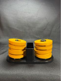 This Modern Sewing O'Weights Rotary Cutting System Organizer includes 10 yellow pattern weights and the matching organizer base. The weights are marke