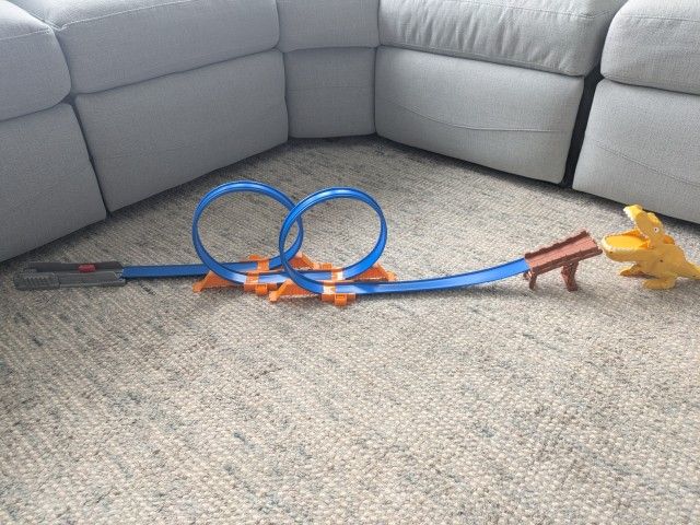 Hot Wheels track with double loop and dinosaur. Nice condition. Some cars work better than others for going through the loop. Does not include Car