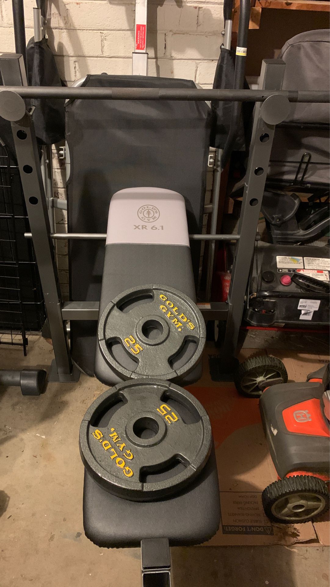 Gold's Gym XR 6.1 Weight Bench (Weight Bench) and Includes a 7' Olympic-style bar (3-piece assembly) and 2x 25-lb round, flat and cast iron plates