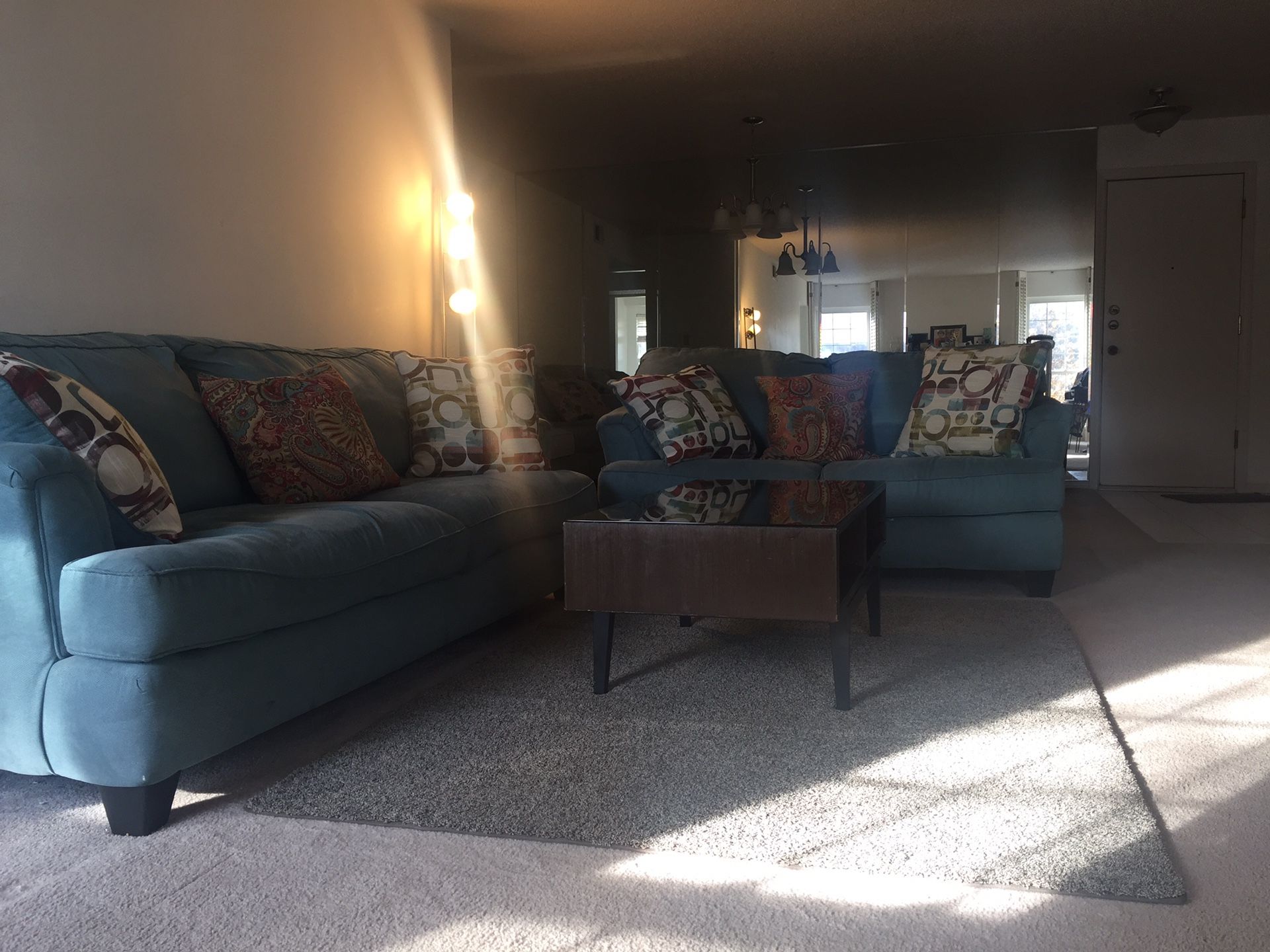 Two sofa, a coffee table, and blue rug.