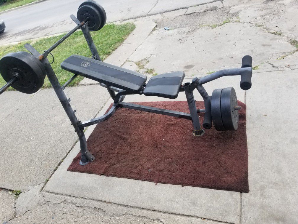USED WEIGHT BENCH AND PLASTIC WEIGHTS 