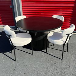 Black Barrel Dining Table And Boucle Chairs 