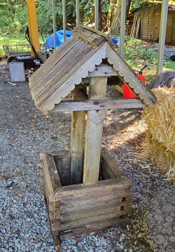 Wooden yard art wishing well