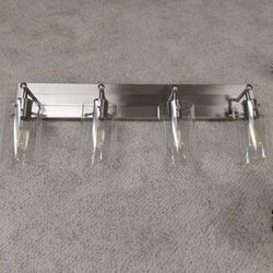 2 brushed nickle and 1 chrome light fixture