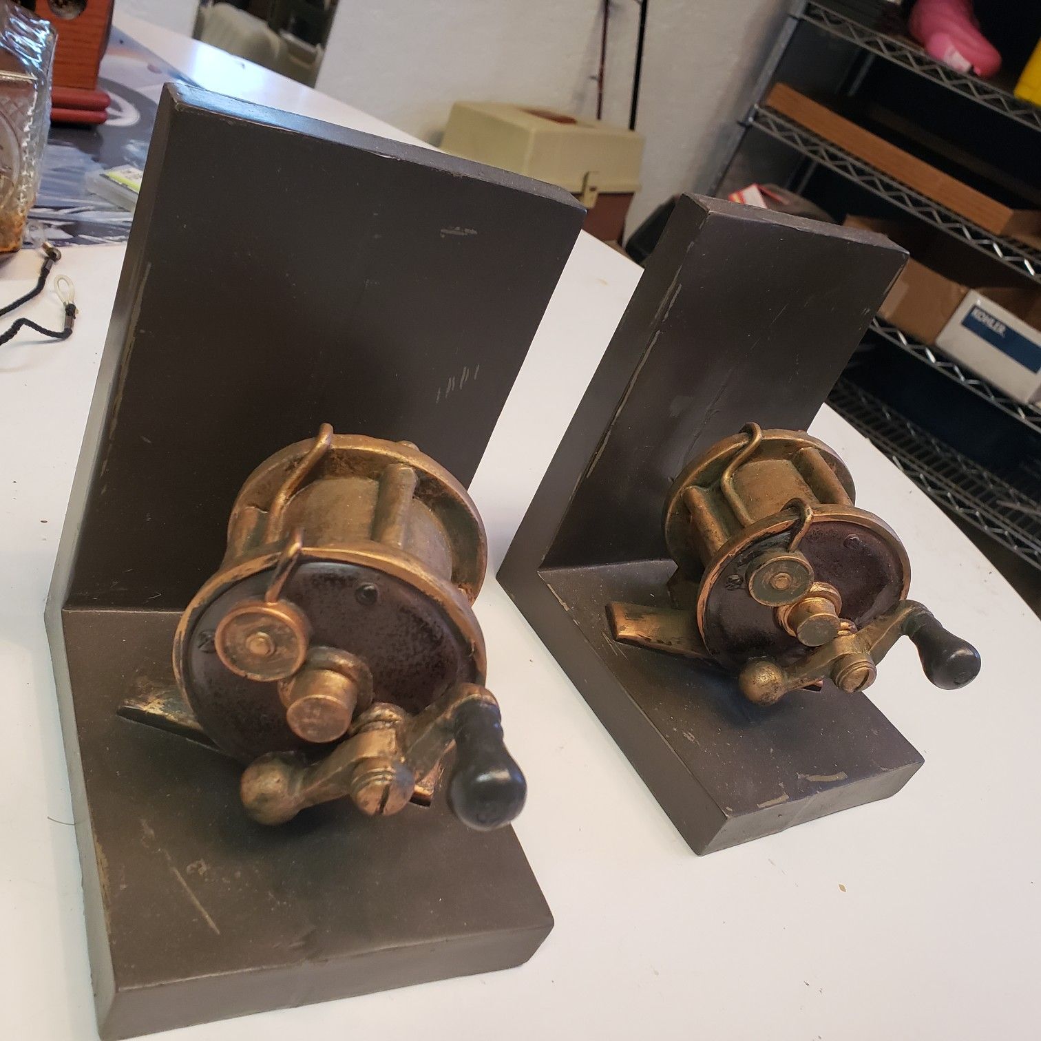 Two bookcase ends fishing reels