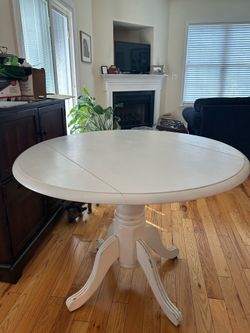 Charming White Round Pedestal Drop-Leaf Table