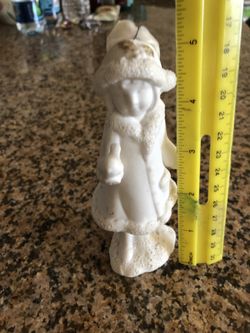 vintage figurine of a girl with a bird