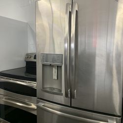Matching stainless steel GE French door refrigerator and electric double oven