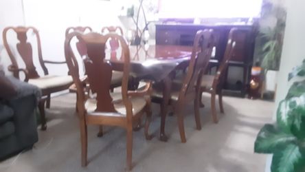Dining table with 6 chairs and a two-seater bench.