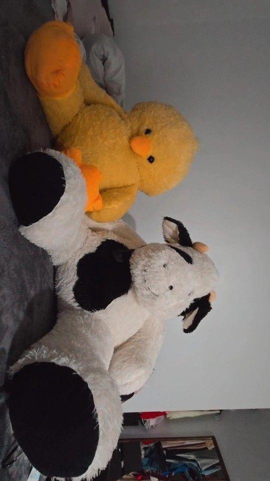 Cow stuffed animals and giant chick