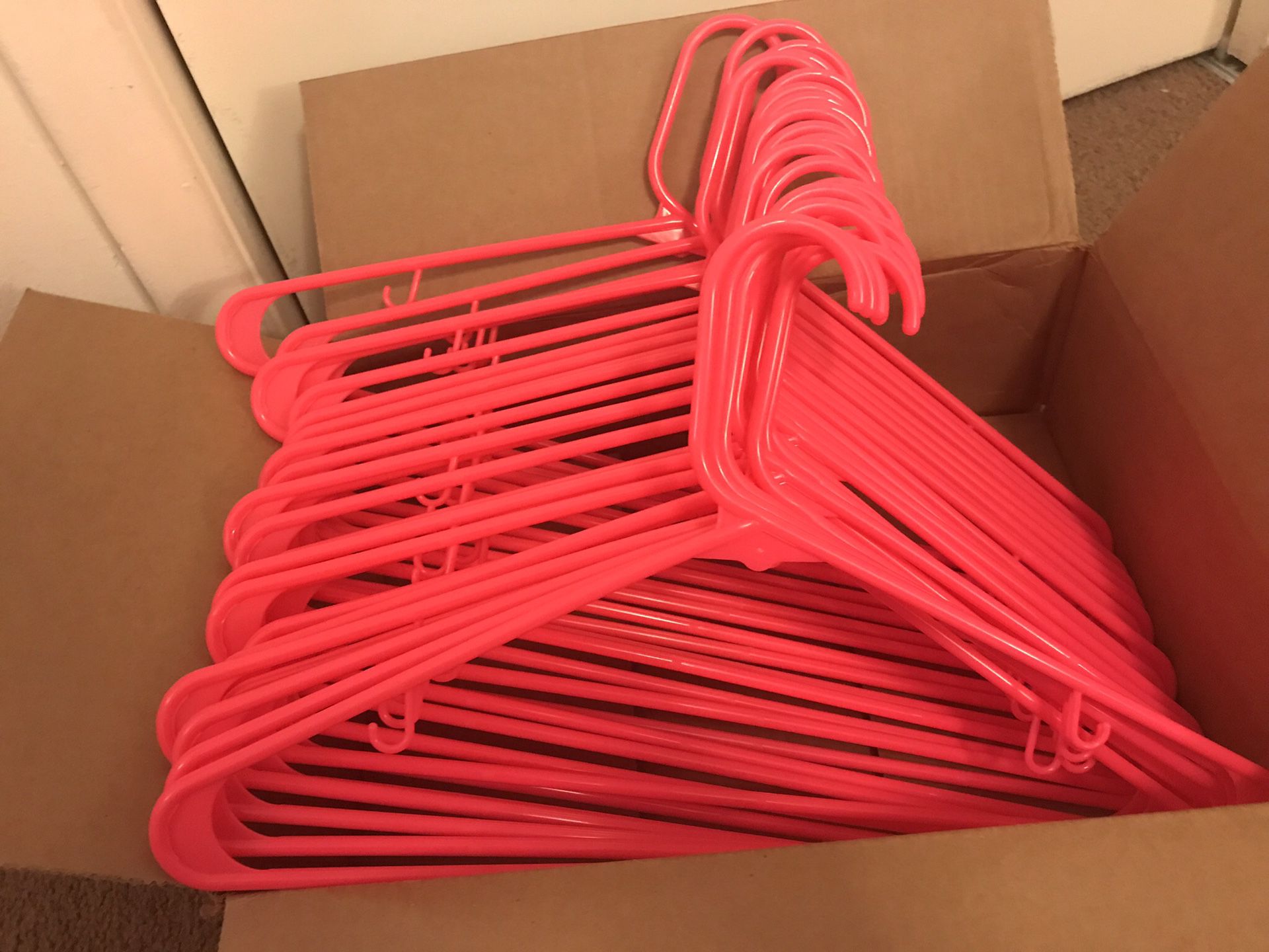 34 pink plastic clothes hangers