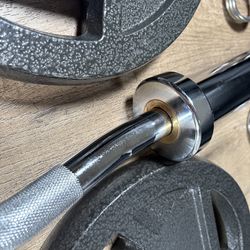 Beautiful BRAND NEW  Equipment: Curl Bar W/Cooper Bearings & Pair of Weight Plates 25s, 10s, 5s And 2.5 Pounds. (Total: 105 lbs)