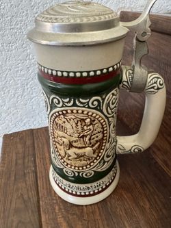 vintage 1978 Avon beer stein, specifically identified as part of the "Sporting" series featuring themes like hunting and fishing.The stein was handcra