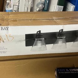 Manor 33 in. 4-Light Matte Black Industrial Bathroom Vanity Light with Clear Glass Shades